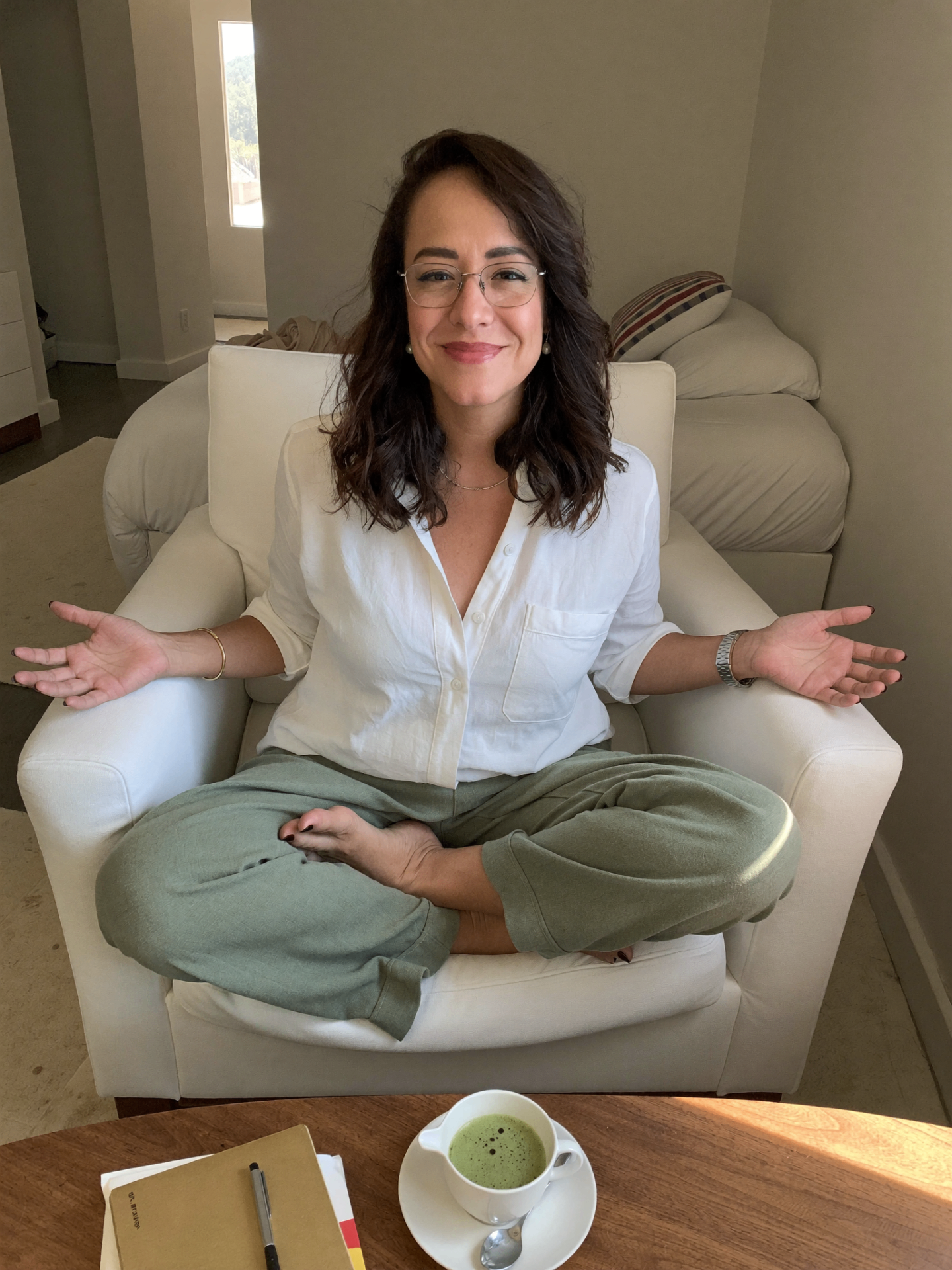Cindy de Viveros, Calgary past life regression practitioner, seated in a relaxed pose